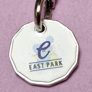 Image showing a close up of a trolley token with the logo of East Park in Glasgow attached to its key ring.